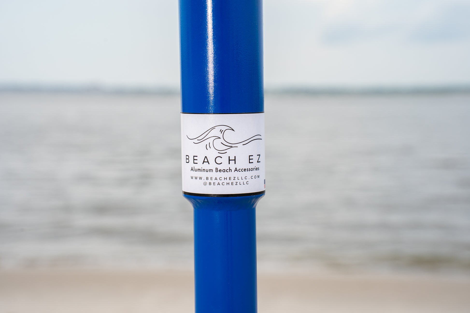 Custom blue aluminum surf fishing rod holder beach spike logo close up