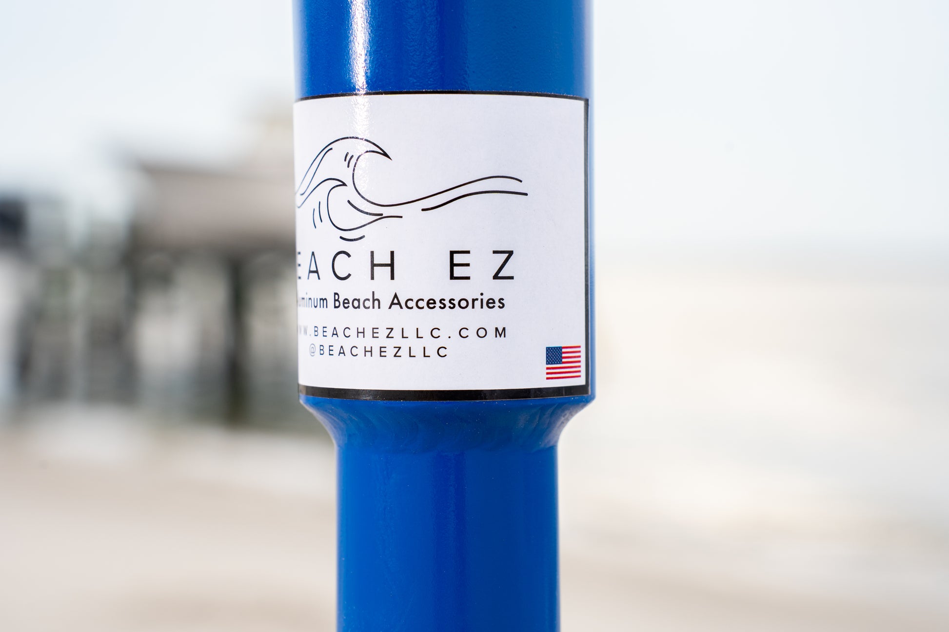 Custom blue aluminum surf fishing rod holder beach spike logo close up