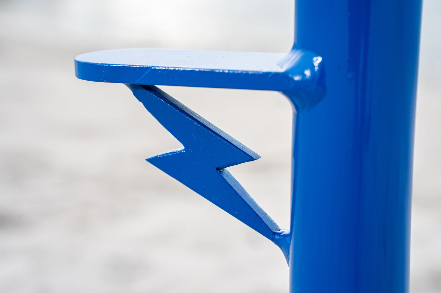 Custom blue aluminum surf fishing rod holder beach spike insignia close up