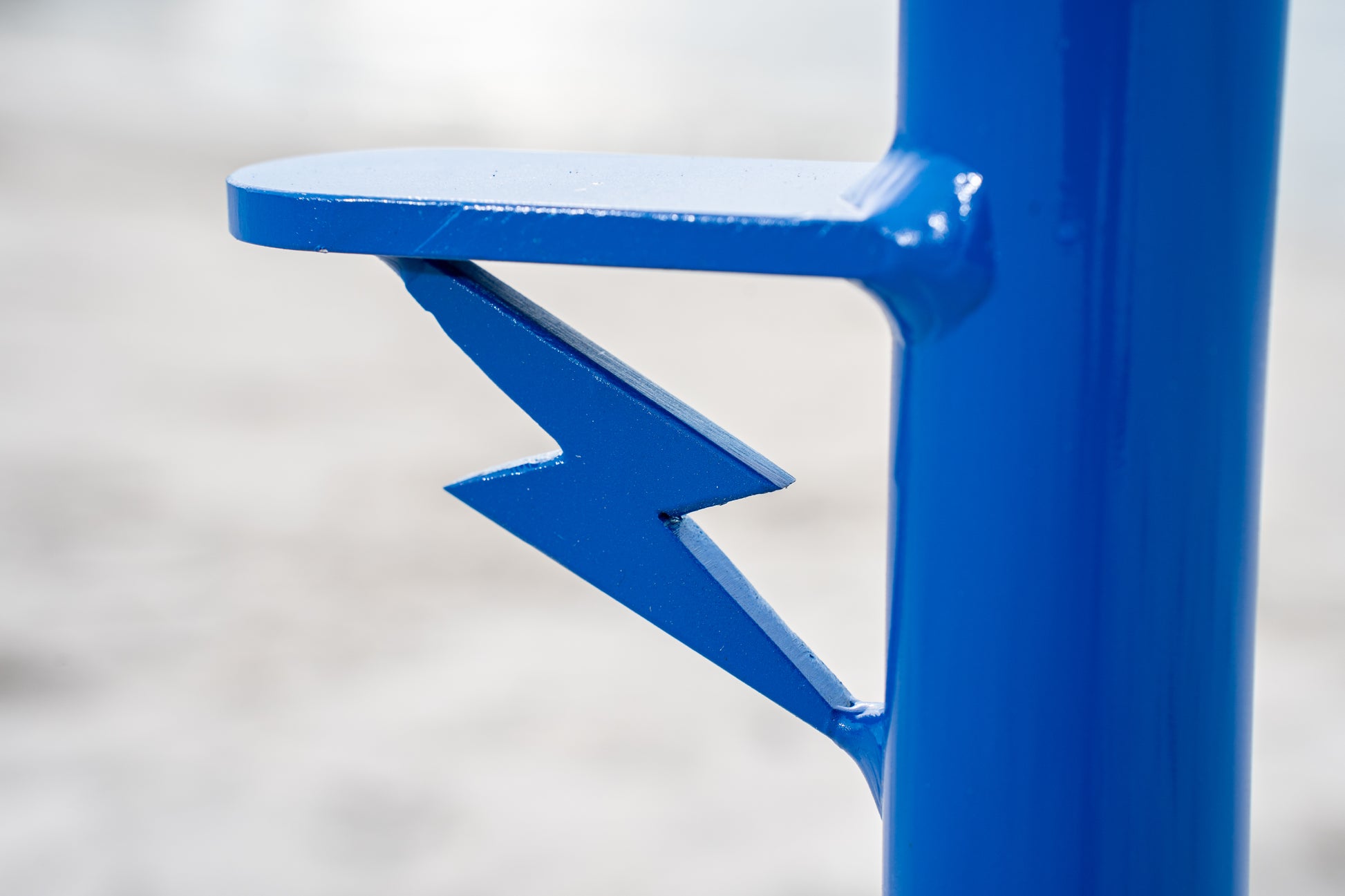 Custom blue aluminum surf fishing rod holder beach spike insignia close up