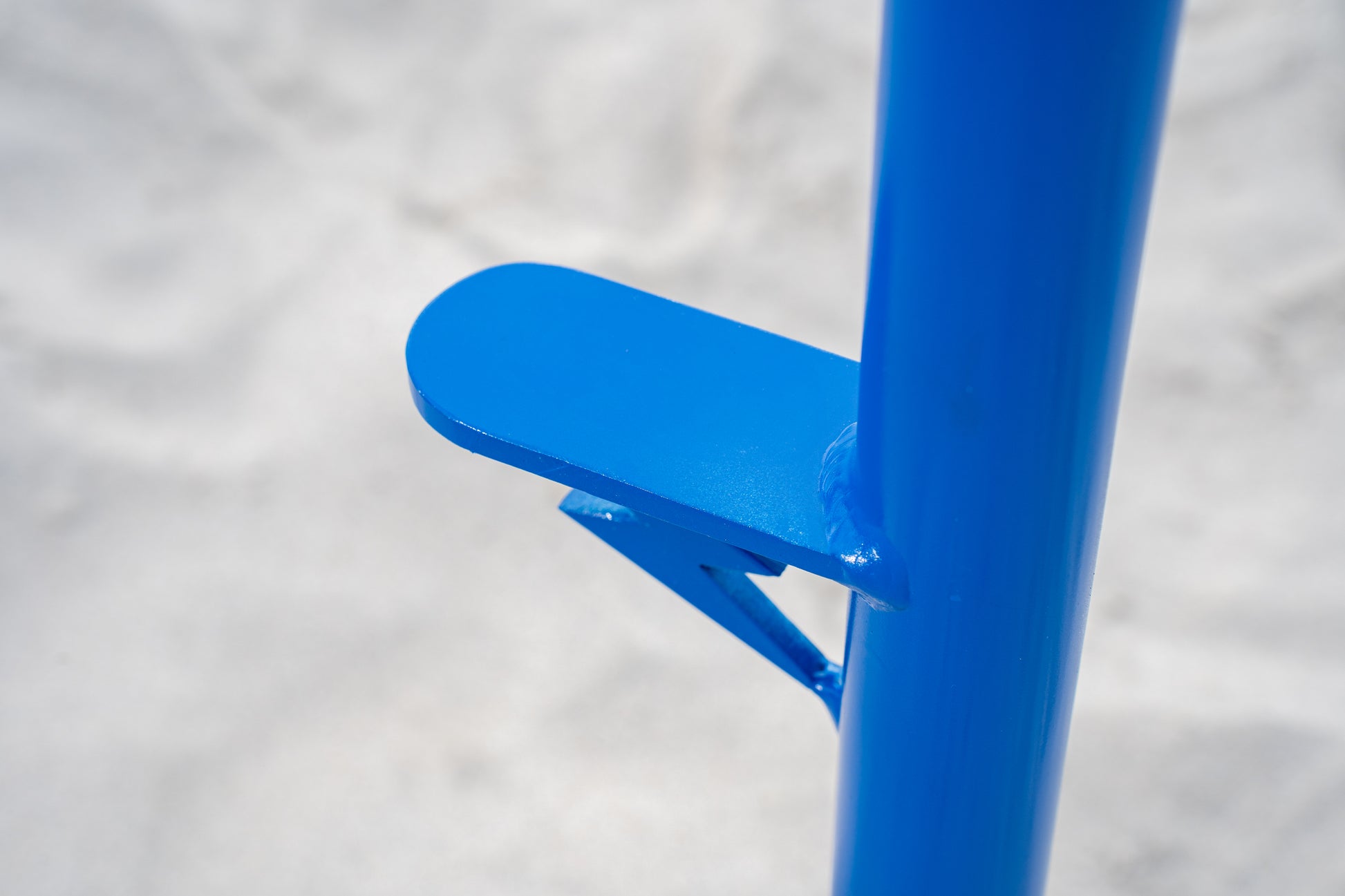 Custom blue surf fishing rod holder beach spike foot close up