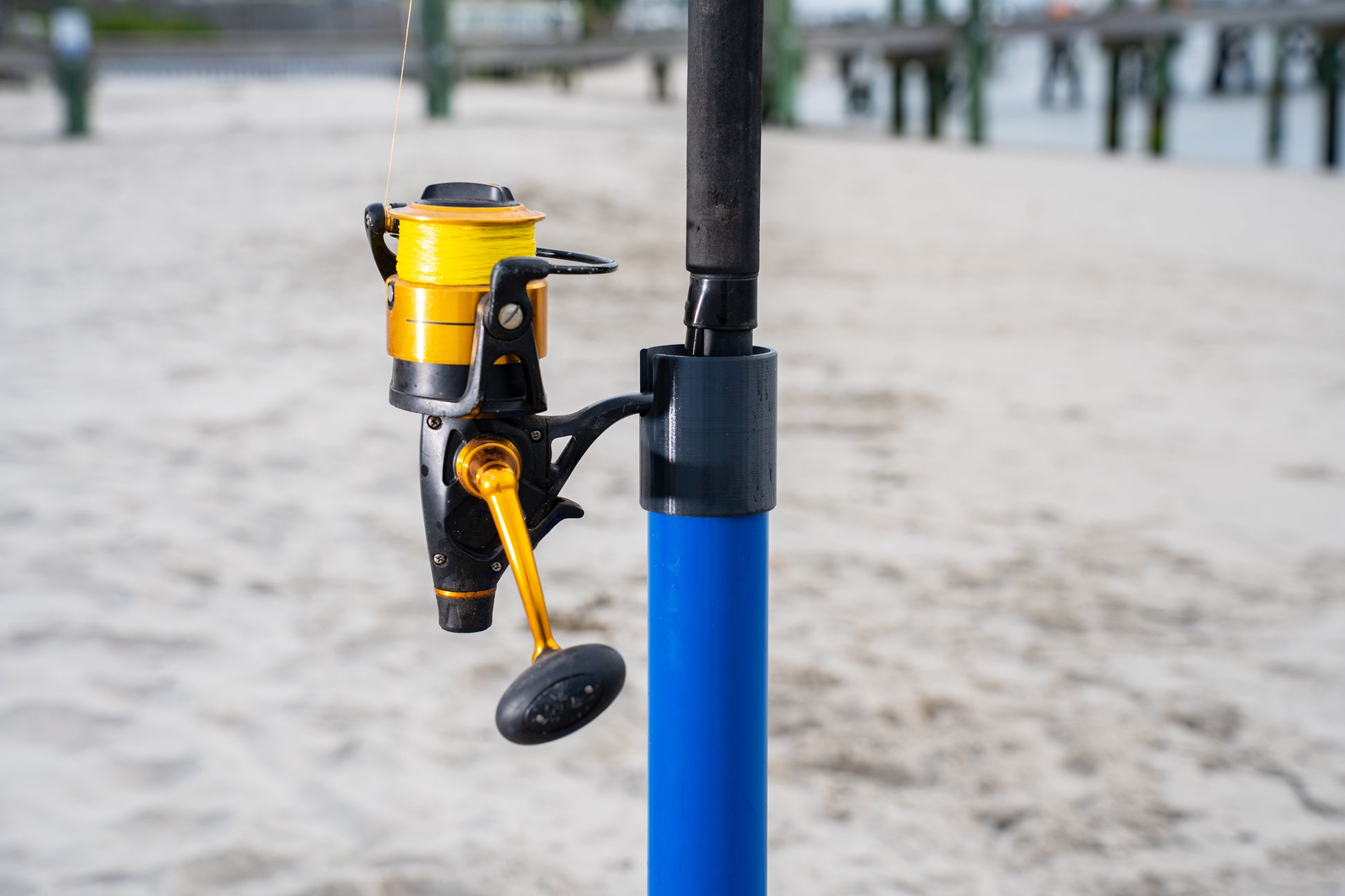 Custom blue aluminum surf fishing rod holder beach spike close up with black 3d printed cap