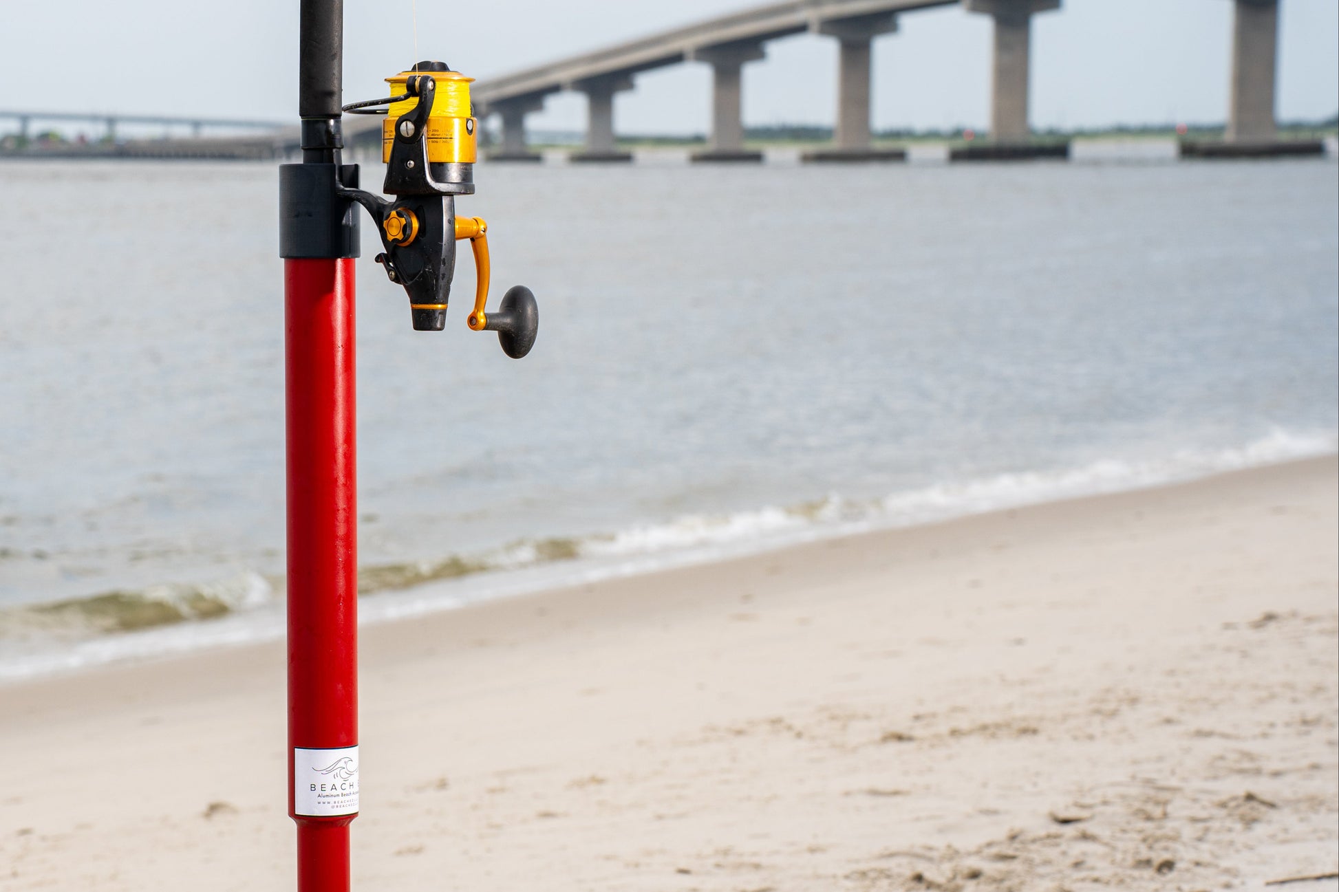 Custom red aluminum surf fishing rod holder beach spike side view