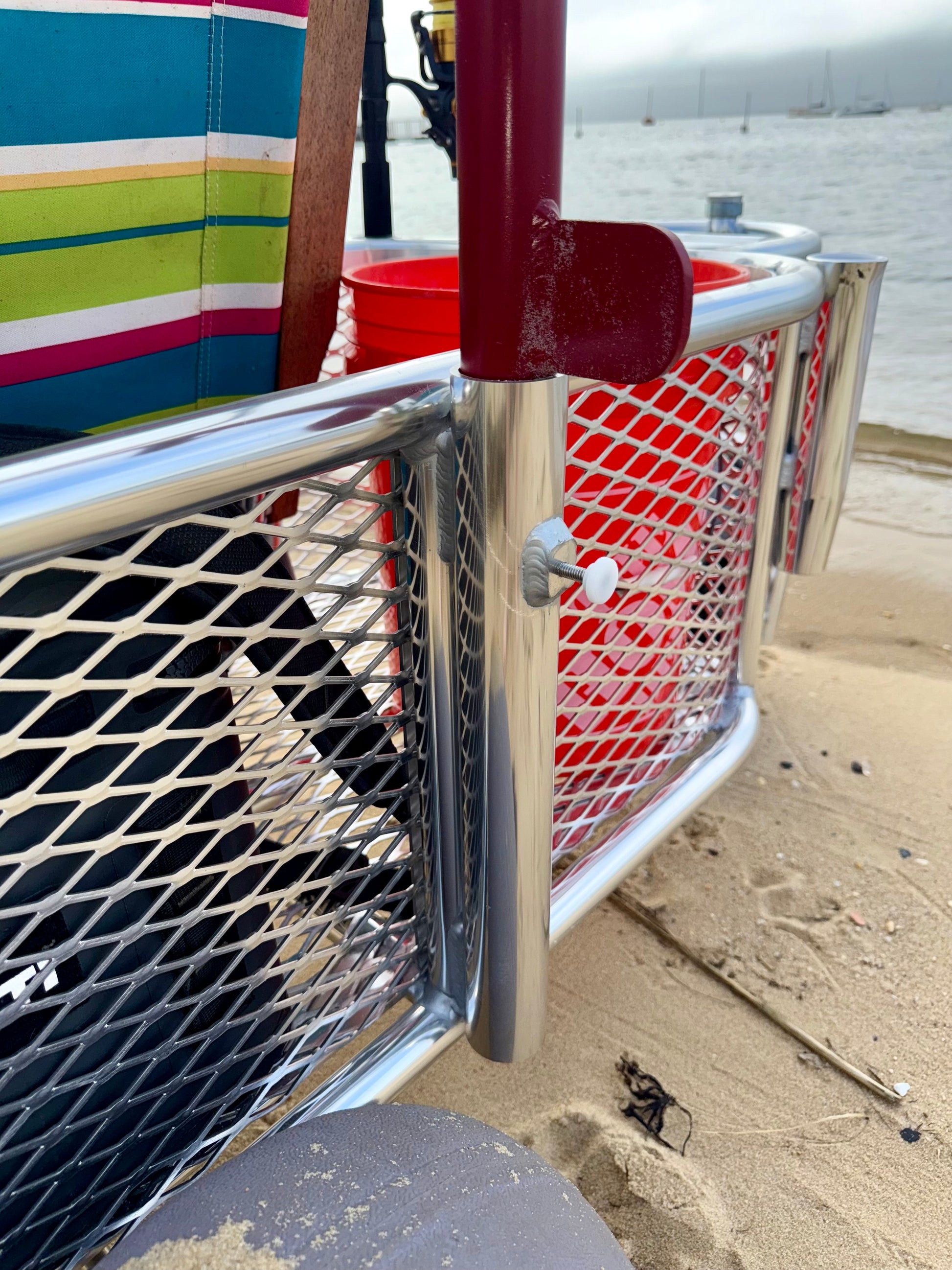 Angler surf fishing buggy, custom aluminum surf fishing cart with rod holders for fishing poles and space for beach gear. close up with gear inside