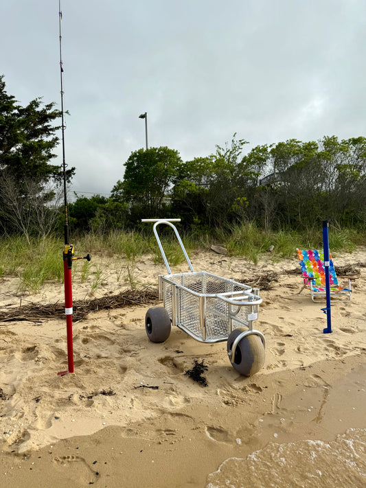 Angler surf fishing buggy, custom aluminum surf fishing cart with rod holders for fishing poles and space for beach gear. also featuring red and blue surf fishing rod holder beach spikes